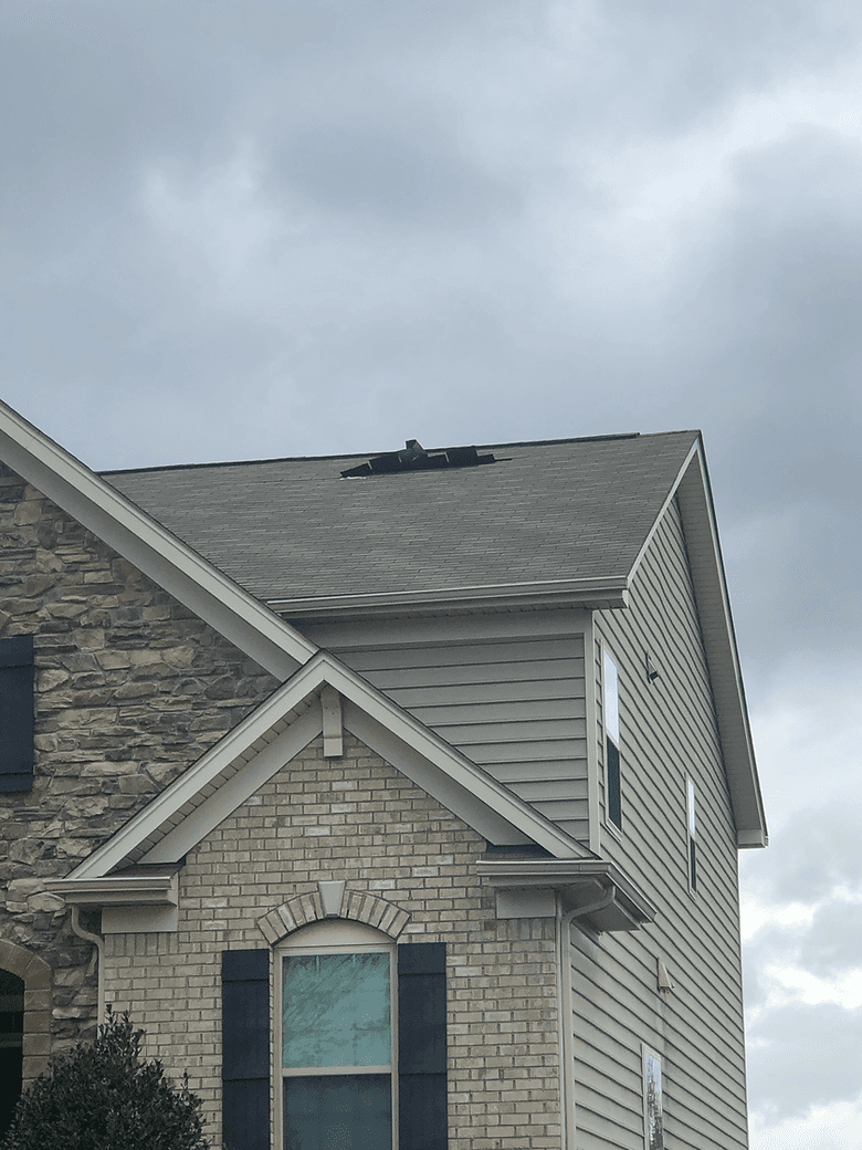 Field representative assessing roof damage for insurance restoration